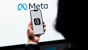 Young man using new meta threads app on smartphone