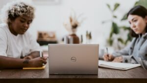 man in white dress shirt using laptop