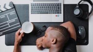 a man sitting at a desk with a laptop and headphones