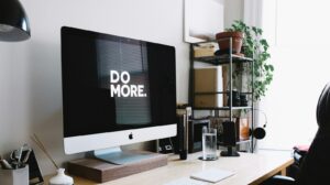 silver iMac with keyboard and trackpad inside room