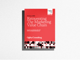 A red and white book titled "Reinventing The Marketing Value Chain" by Ogilvy Consulting lies on a light gray surface.