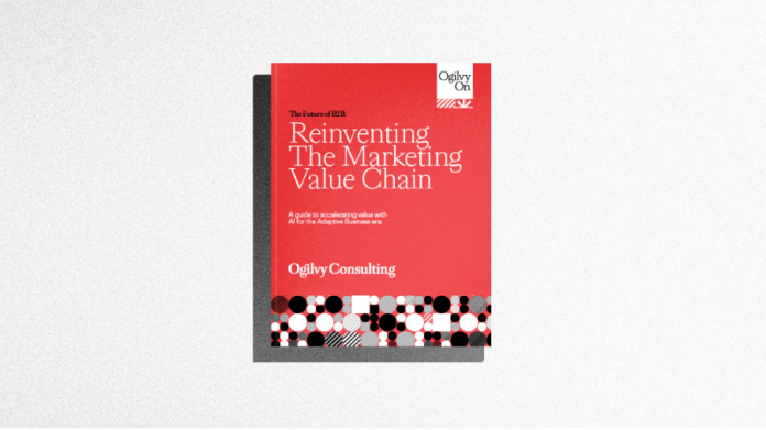 A red and white book titled "Reinventing The Marketing Value Chain" by Ogilvy Consulting lies on a light gray surface.