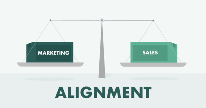 A balanced scale with boxes labeled "Marketing" and "Sales," illustrating the concept of sales-marketing alignment for effective lead generation between these two departments.